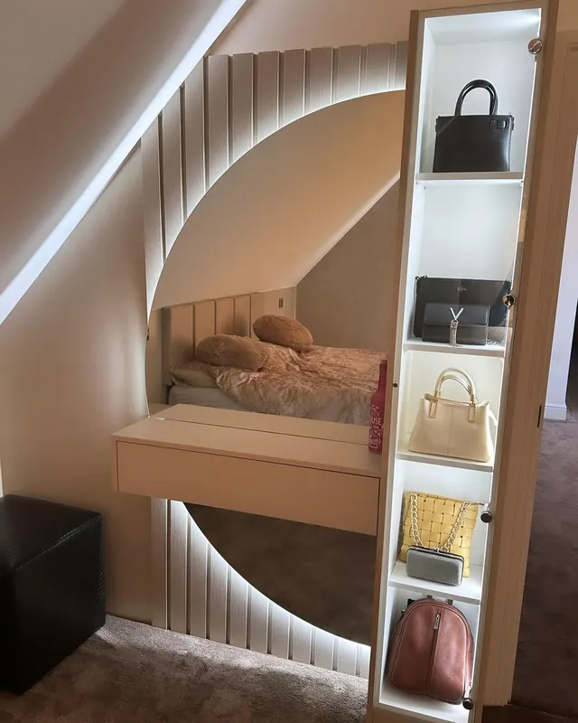 Slim lit display wardrobe for handbags next to a curved mirror