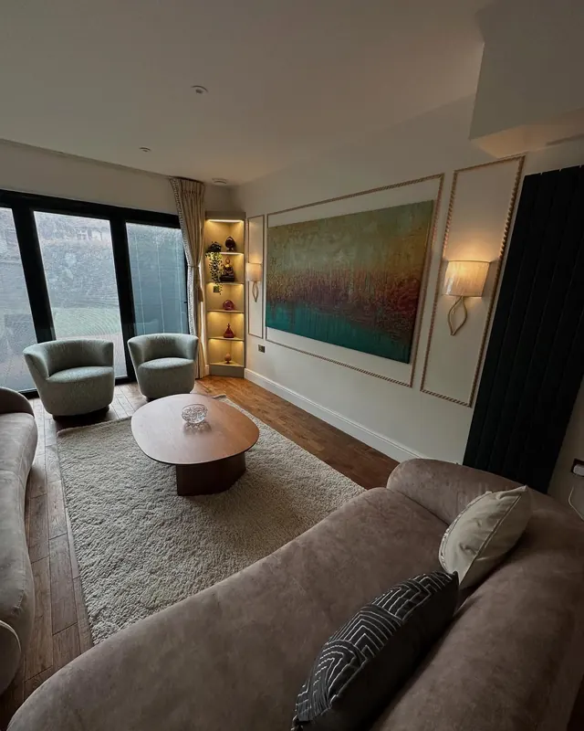 Living room with fluted panels and a lit display unit