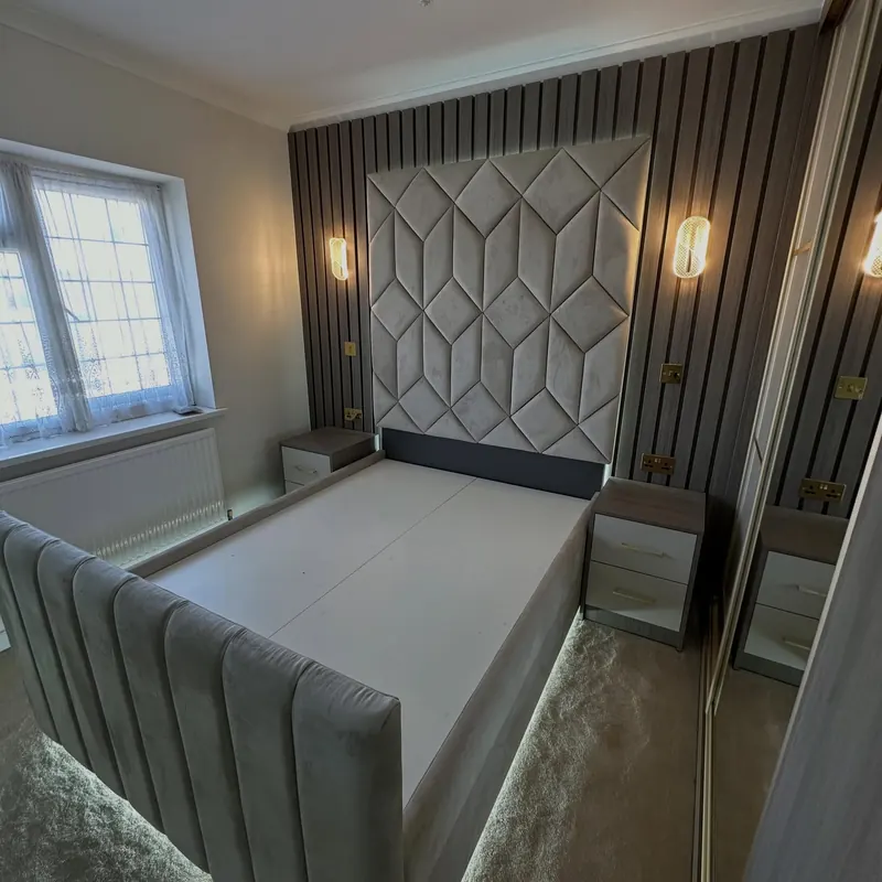Fitted bed with a padded geometric headboard and a panelled feature wall