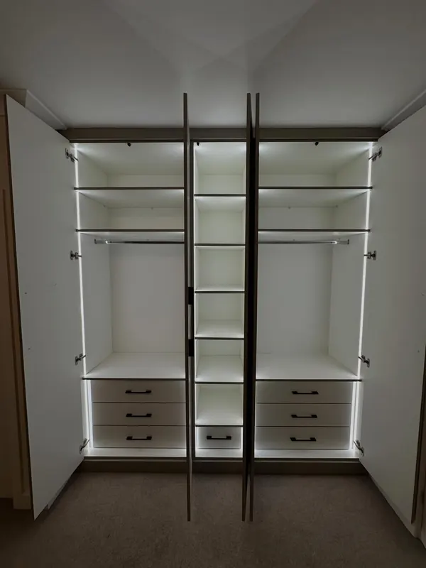 White wardrobes open with LED strips down every shelf