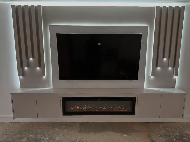 Media wall with a recessed TV, electric fire and lit alcoves