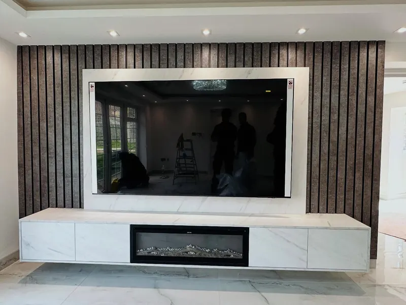 Media wall with slatted dark panels, fire and floating unit