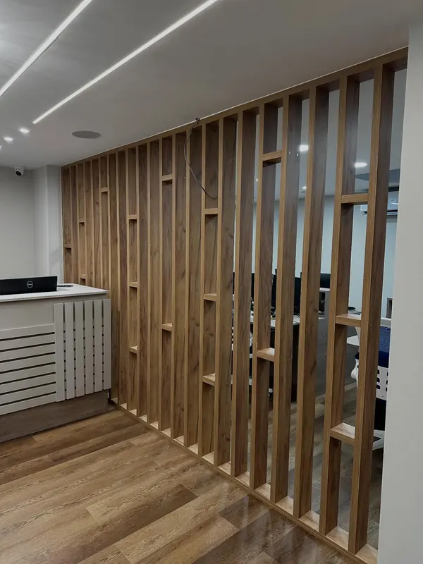 Oak slatted room divider with lit ceiling strips